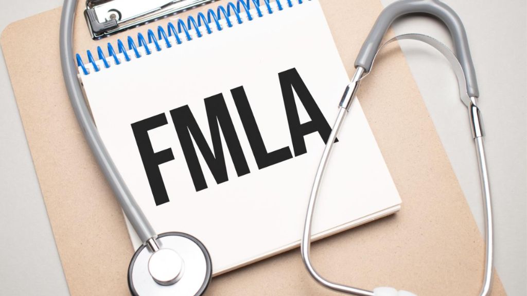 FMLA paperwork surrounded by a stethoscope